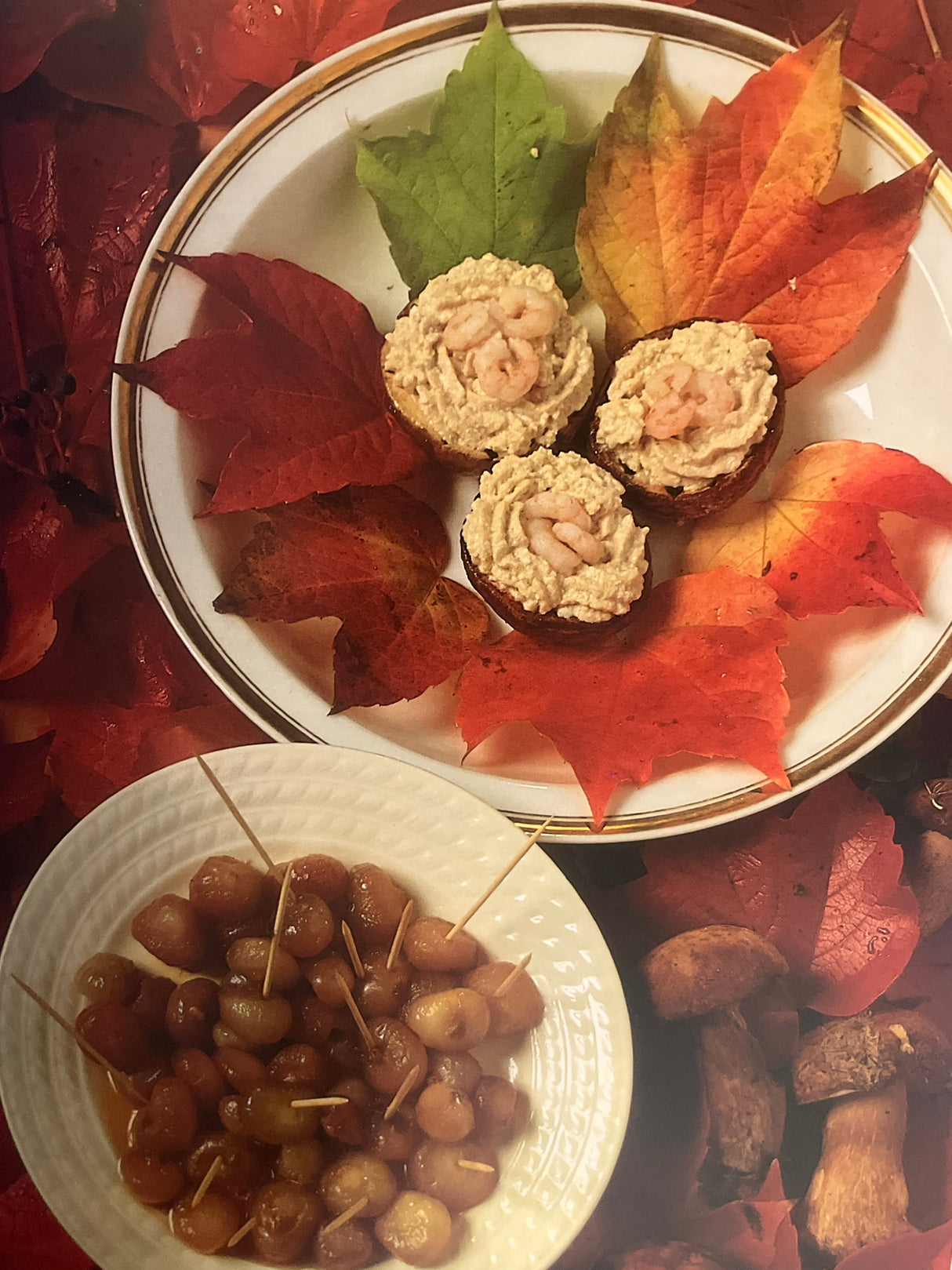 The Villa Table showcasing autumn hors d'œuvre with creamy shrimp mousse tartlets and pickled pearl onions, set amidst fall leaves for a seasonal touch.
