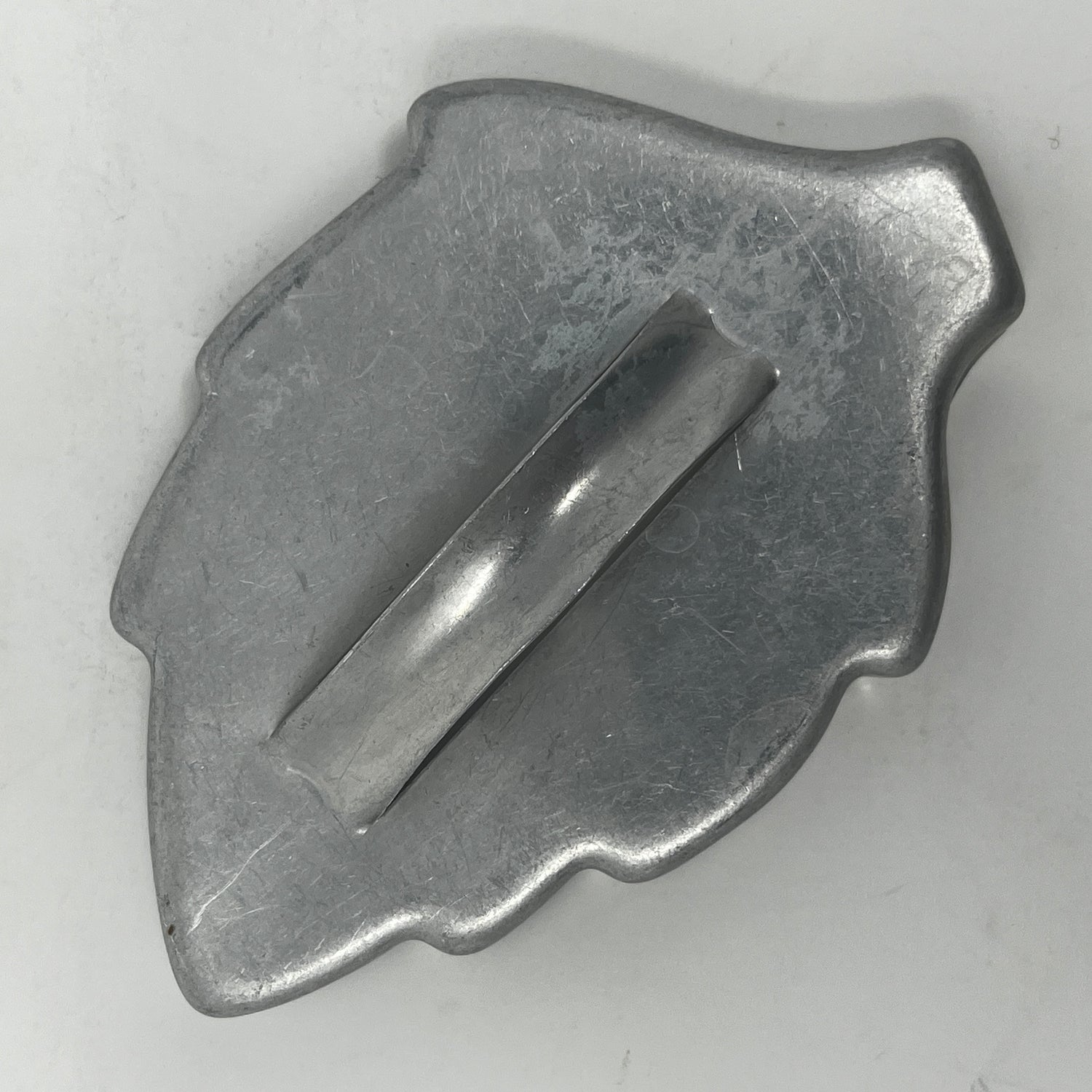 Mid century metal cookie cutter with a long handle, designed for easy gripping, suitable for creating various shapes including Christmas and celestial themes.