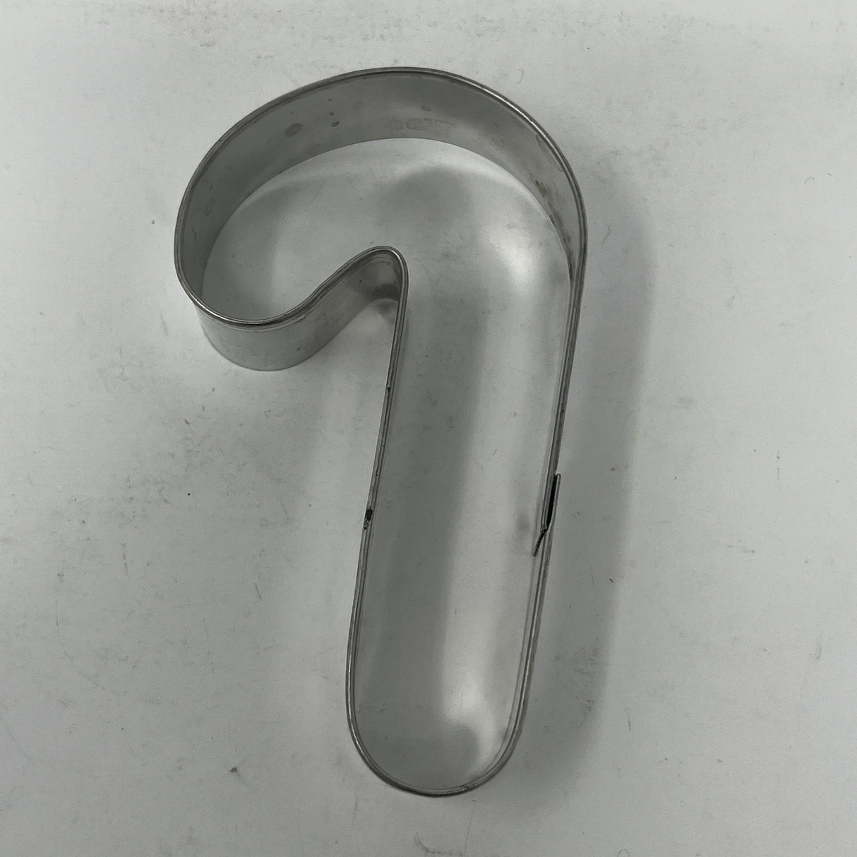 Mid-century metal cookie cutters featuring adaptive handles for easy grip, including vintage designs from the 1930s like Pillsbury's Comicooky Cutter, moons, stars, and holiday shapes.