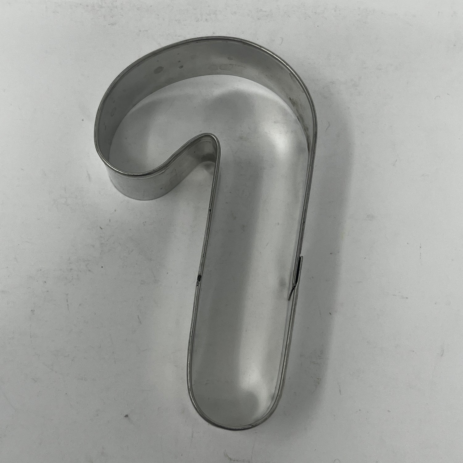 Mid-century metal cookie cutters featuring adaptive handles for easy grip, including vintage designs from the 1930s like Pillsbury's Comicooky Cutter, moons, stars, and holiday shapes.