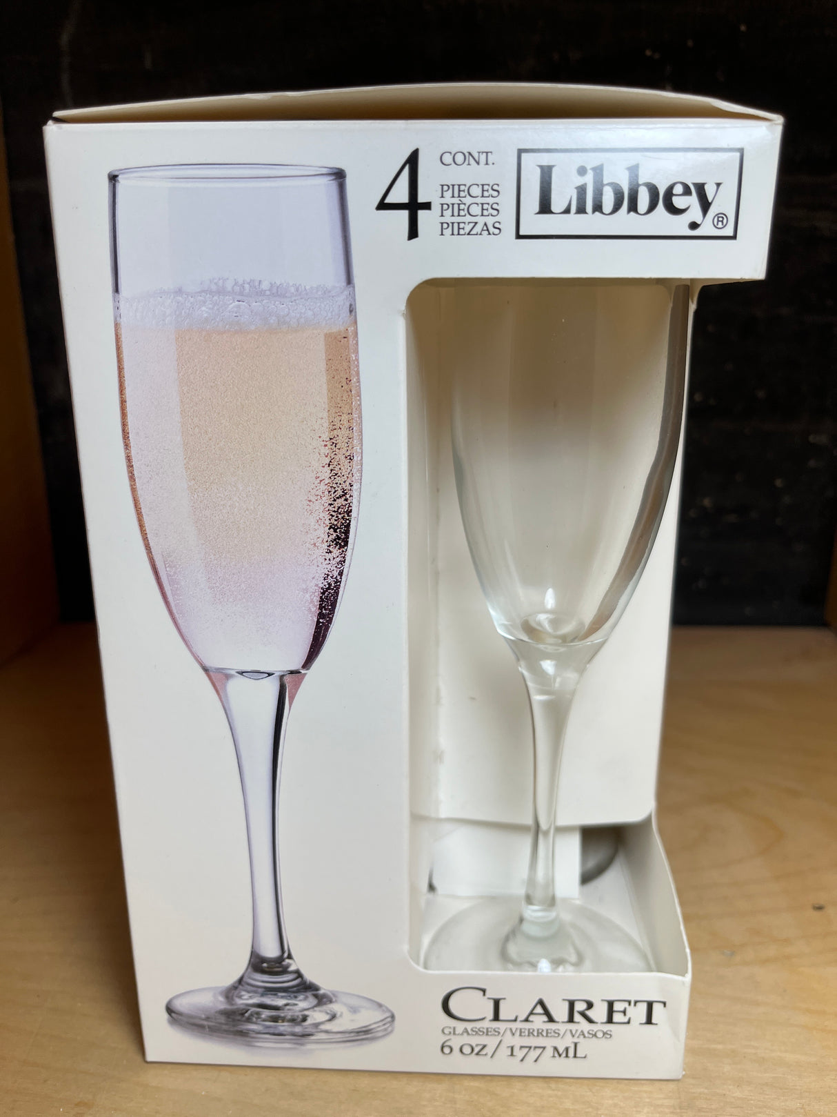 Libbey set of 4 champagne clary glasses, visible in packaging with one clear 6 oz glass through a cut-out, labeled as containing four pieces.