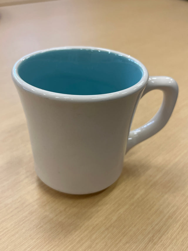 1950s Genuine Taylor ceramic diner mug, white with a blue rim and teal interior, showcasing a durable handle, perfect for coffee.