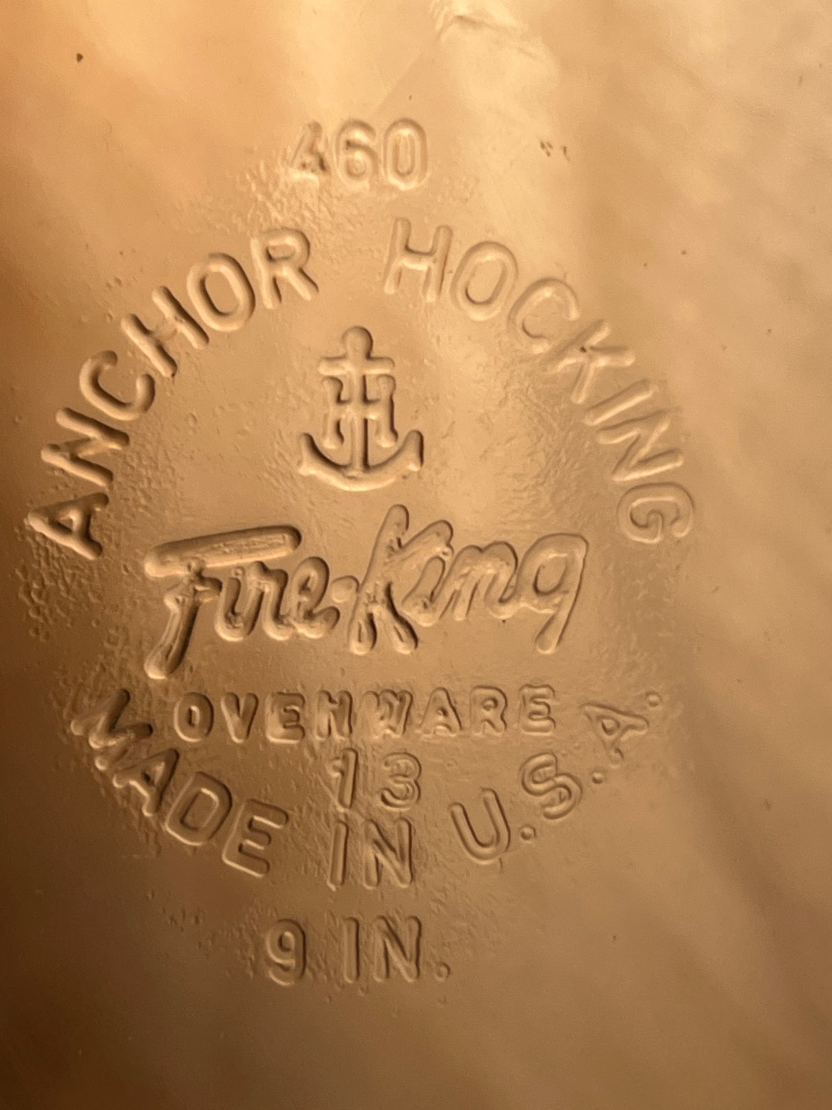 Embossed underside of a 9-inch vintage glass Fire-King Anchor Hocking 460 pie plate, featuring maker’s mark and “Made in U.S.A.” details.