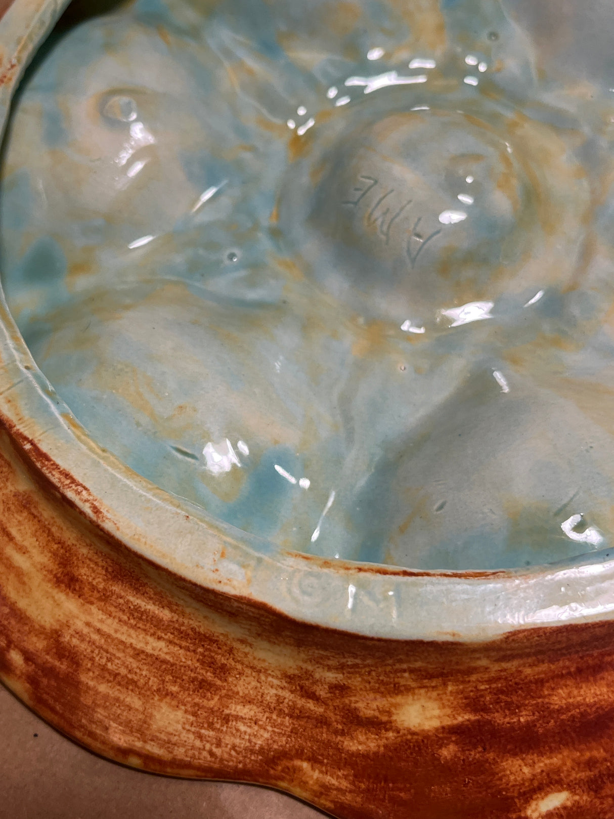 RARE French majolica oyster plate with six scallop-shaped wells and central well, featuring an aqua-green glaze and artist's mark, showcasing 19th-century craftsmanship.