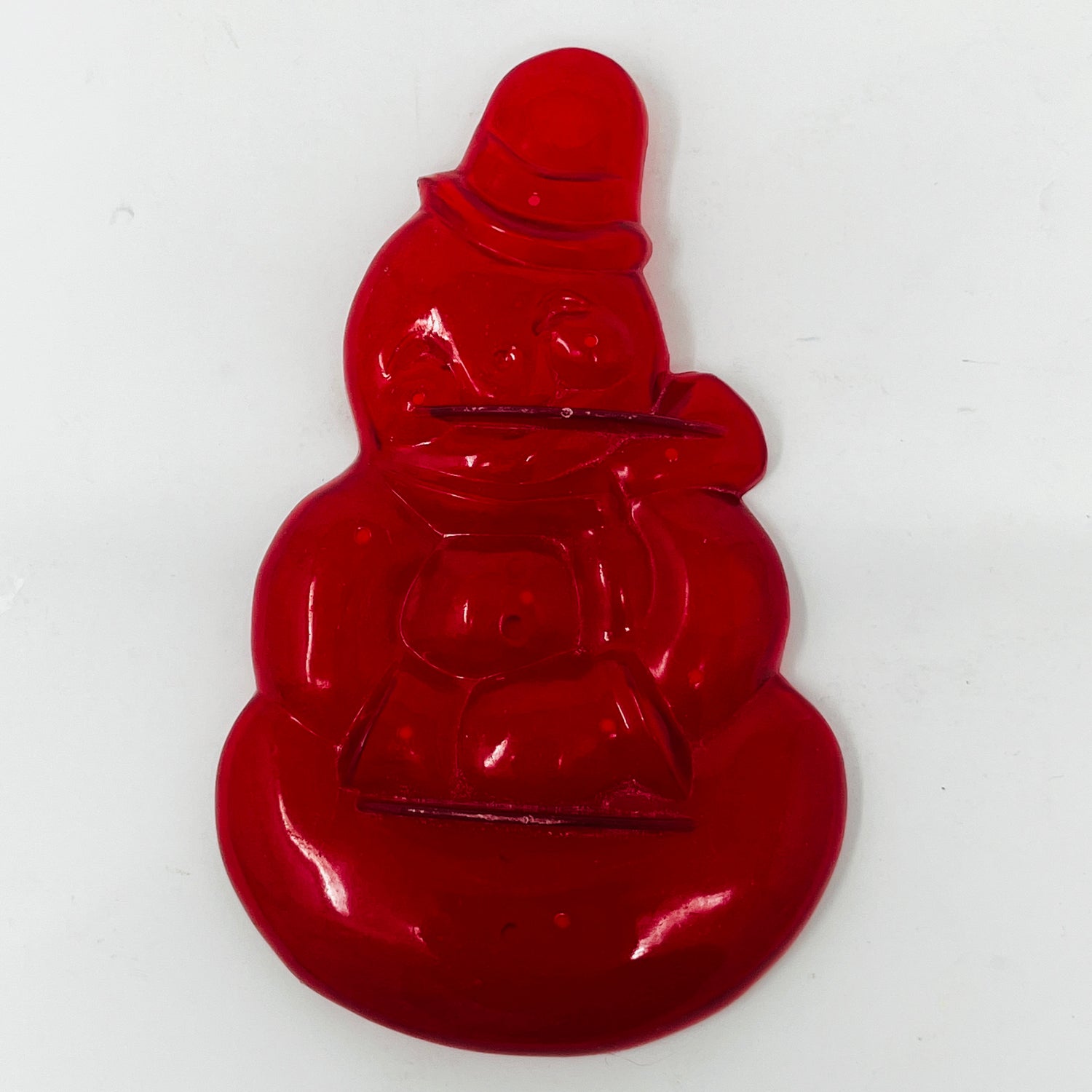 Red snowman-shaped vintage cookie cutter with hat and bag, some with Crown logo.