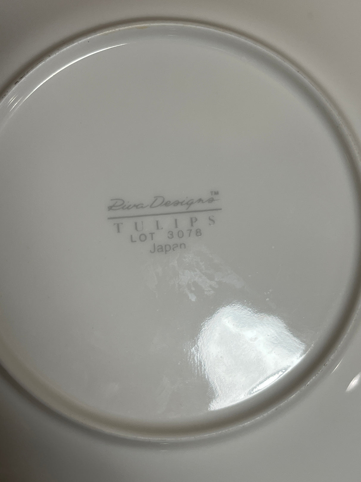 Underside view of Rival Designs Tulip dinnerware piece from Lot 3078, featuring Diva Designs™ maker’s mark, TULIPS, and Japan stamp.