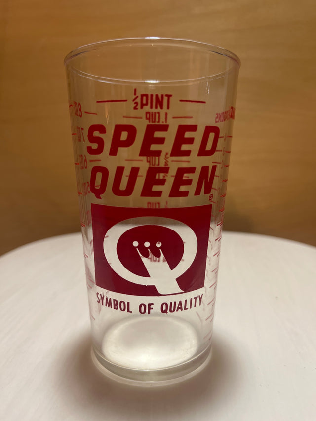 Speed Queen glass measuring cup with a ½-pint capacity, featuring red SPEED QUEEN branding, a stylized Q logo, SYMBOL OF QUALITY tagline, and fluid ounce markings.