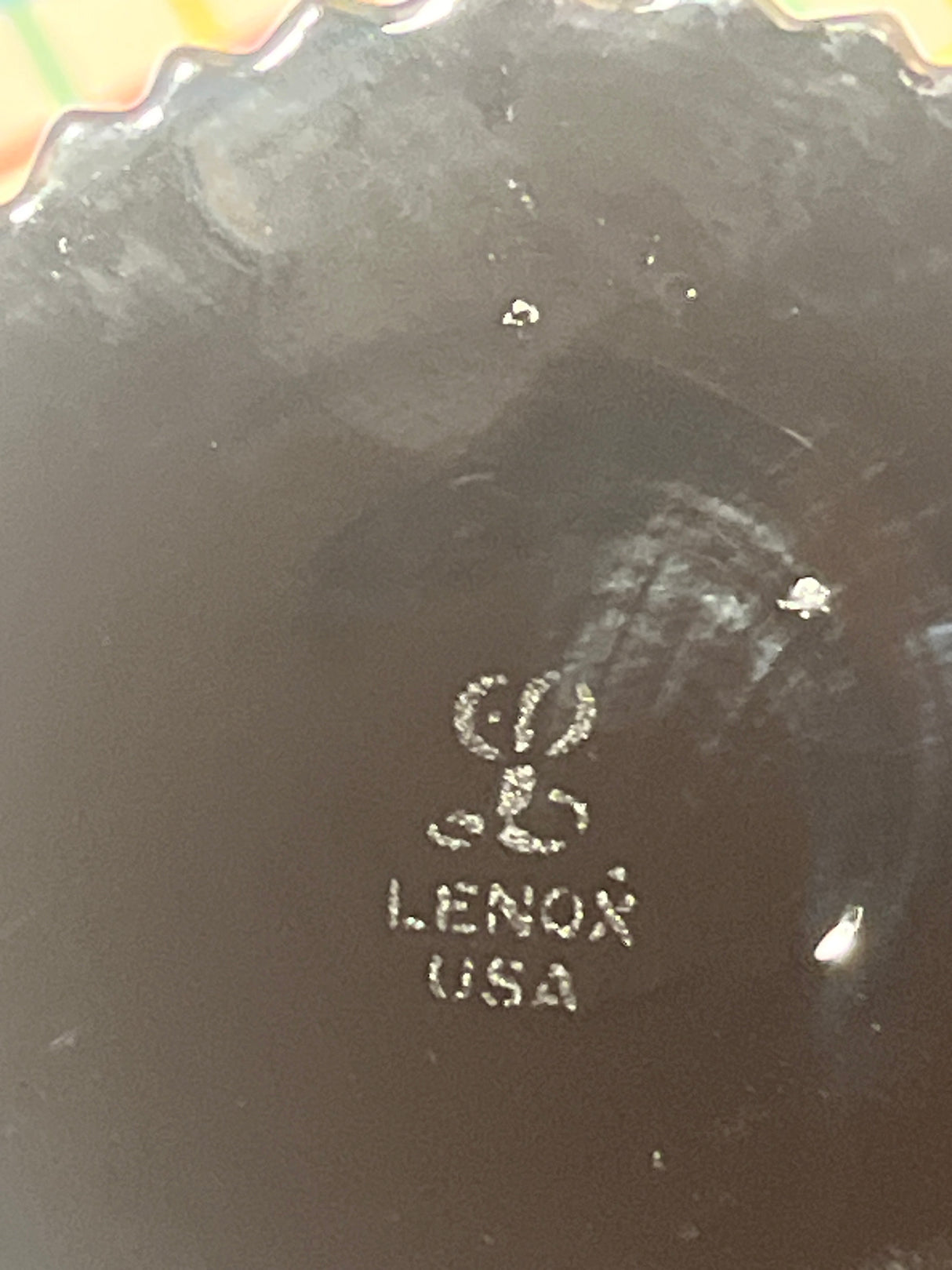 Maker’s mark on the bottom of a Lenox porcelain dish, showcasing the stylized “L” logo over “LENOX USA,” representing the vintage Lenox Nutmeg line water goblets.