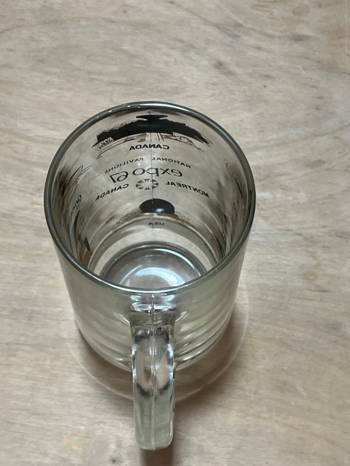67 Montreal Expo souvenir mug featuring a vintage design of the Canada Pavilion and Expo 67 details, printed inside a clear glass beer-style tankard.