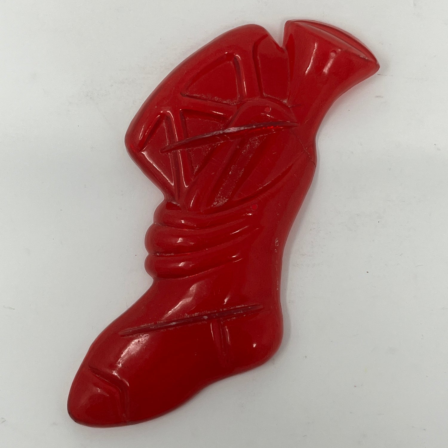 Red plastic mid century cookie cutters with various shapes including a knot and a hole.