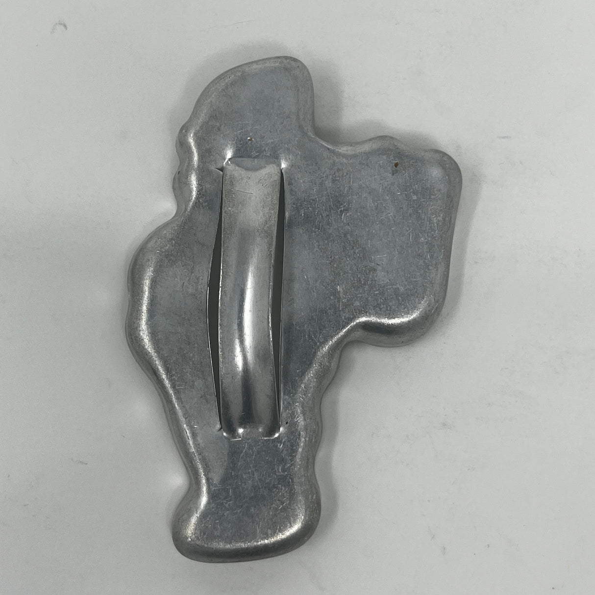 Mid-century metal cookie cutter with a large handle, designed for easy grip. Features celestial and holiday shapes, reflecting 1930s style.