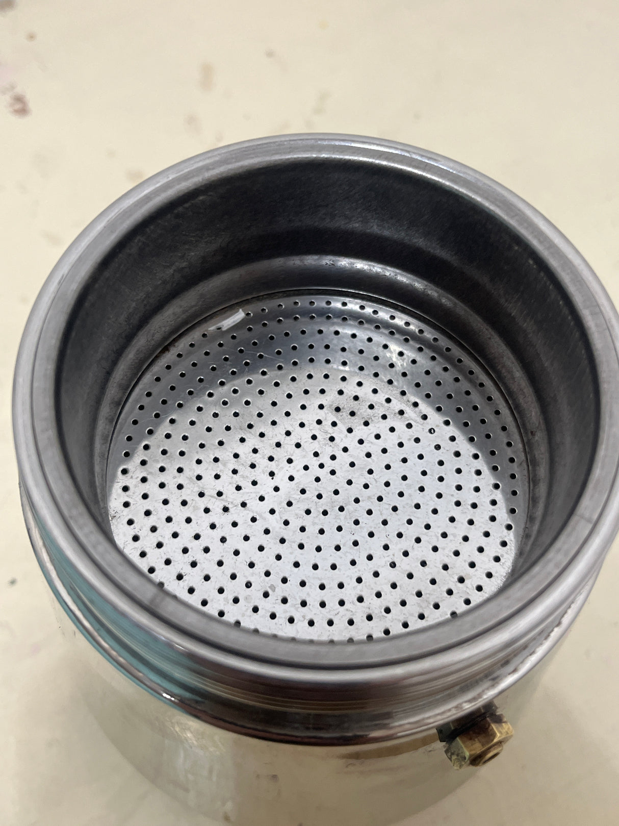 Ilsa Turbo Express 6-Cup 18/10 stainless steel stovetop espresso pot, showing a clean metal coffee-grounds funnel with a perforated filter plate, inside view.