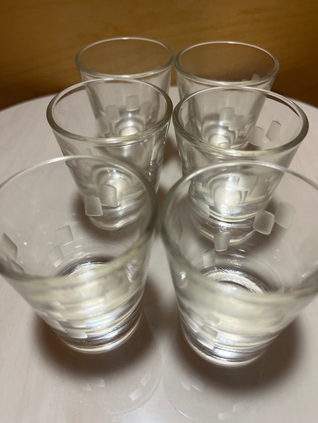 Anchor Hocking cubist shot glass set of six, featuring clear glass with frosted square-pattern etching, elegantly displayed on a white surface.