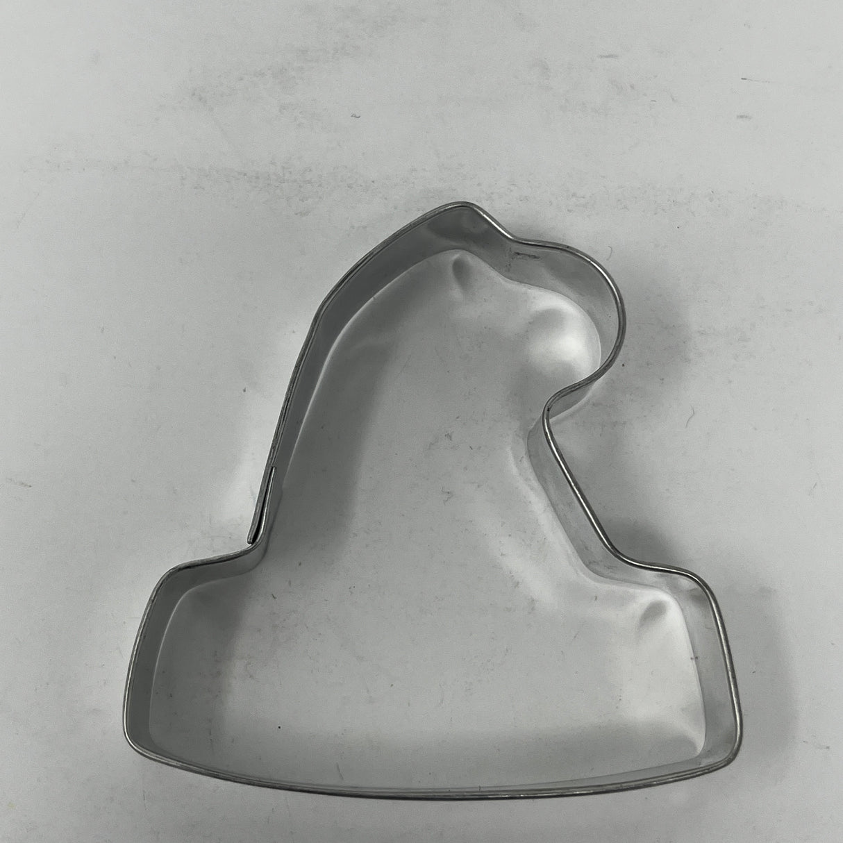 Mid-century metal cookie cutter in a bell shape, part of a collection featuring adaptive handles for easy grip, inspired by 1930s designs.