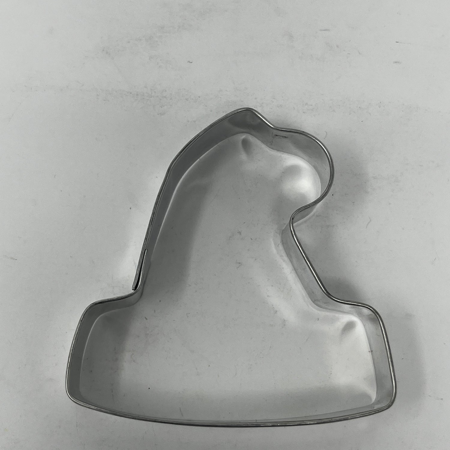 Mid-century metal cookie cutter in a bell shape, part of a collection featuring adaptive handles for easy grip, inspired by 1930s designs.