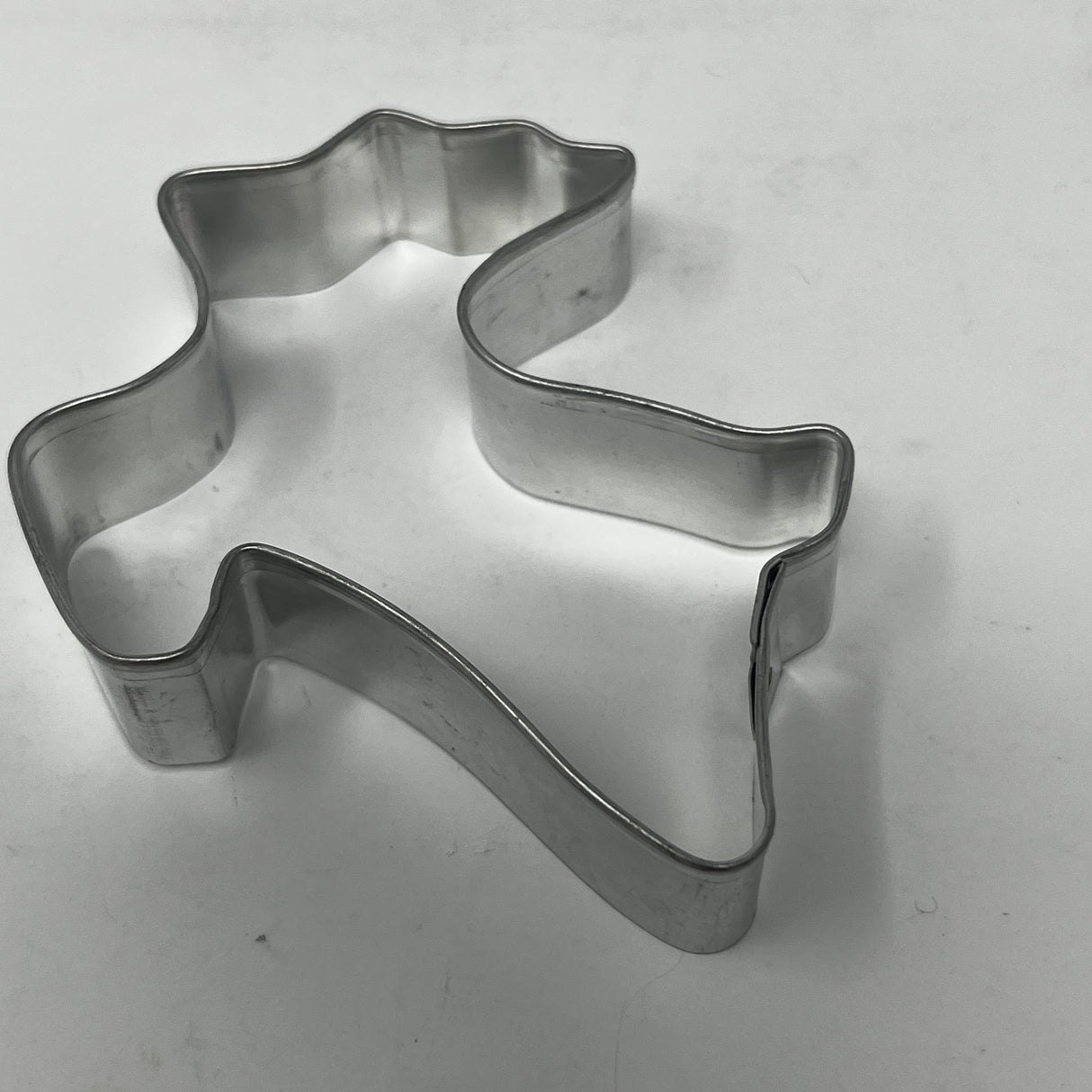Mid-century metal cookie cutter shaped like a ghost, featuring an adaptive large handle for easy grip, part of a unique collection.