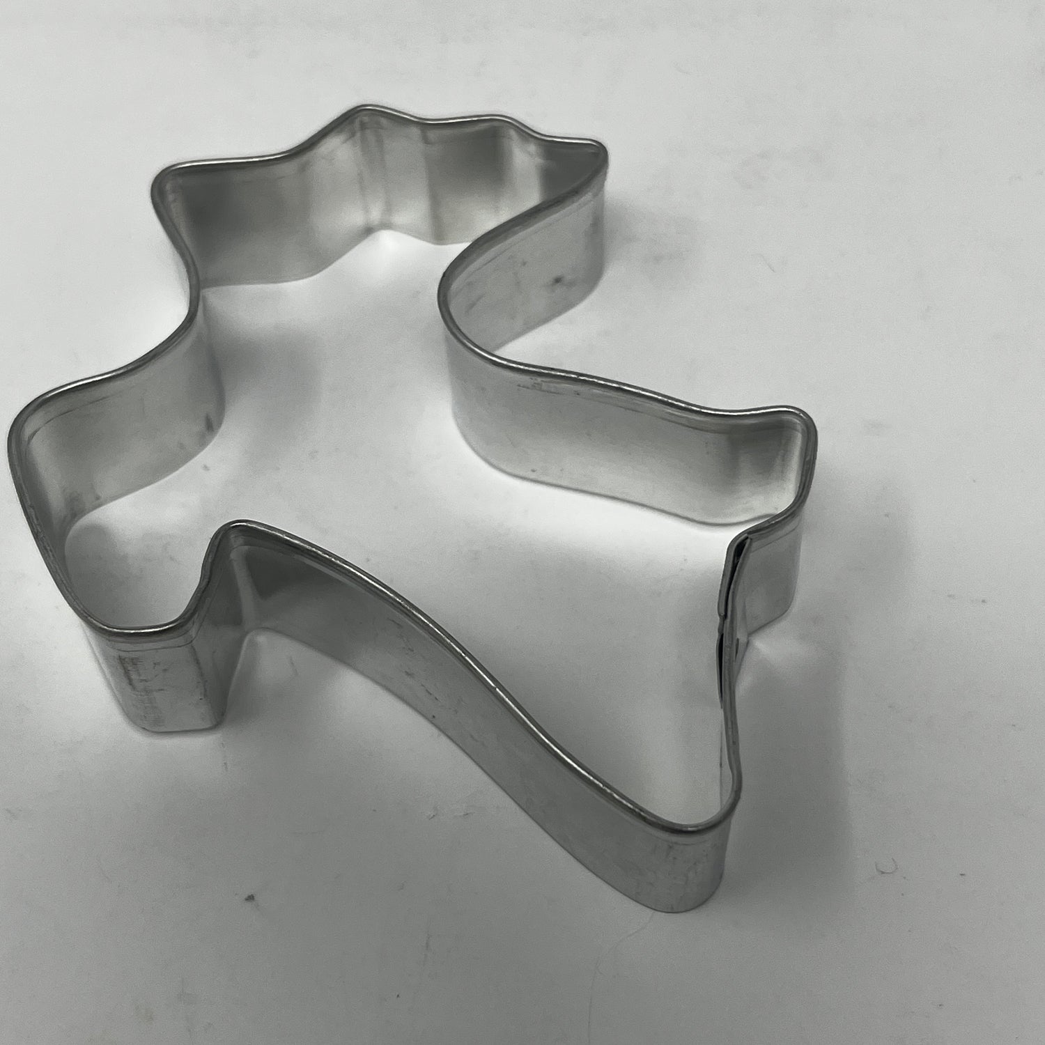 Mid-century metal cookie cutter shaped like a ghost, featuring an adaptive large handle for easy grip, part of a unique collection.