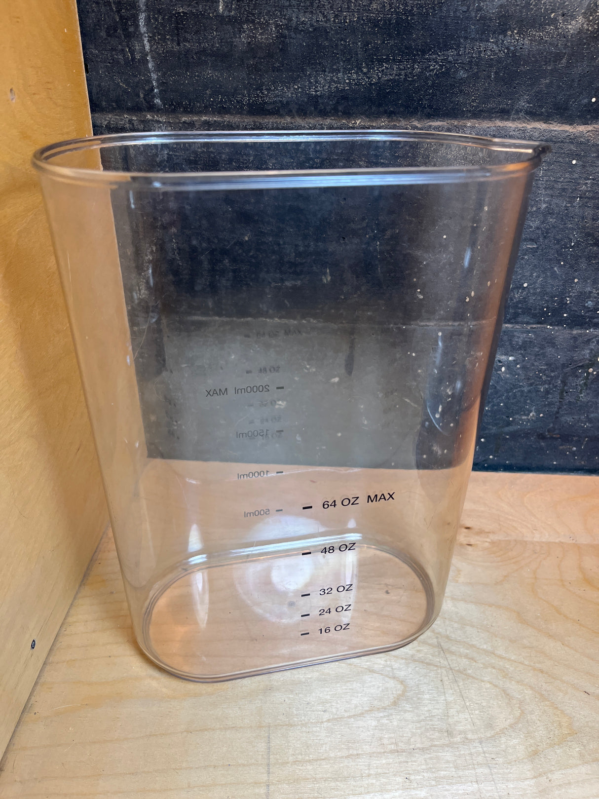 Cuisinart stick blender and whisk set HB-800PC in clear plastic container with volume markings, showcasing its dual use as a mixing/measuring bowl.