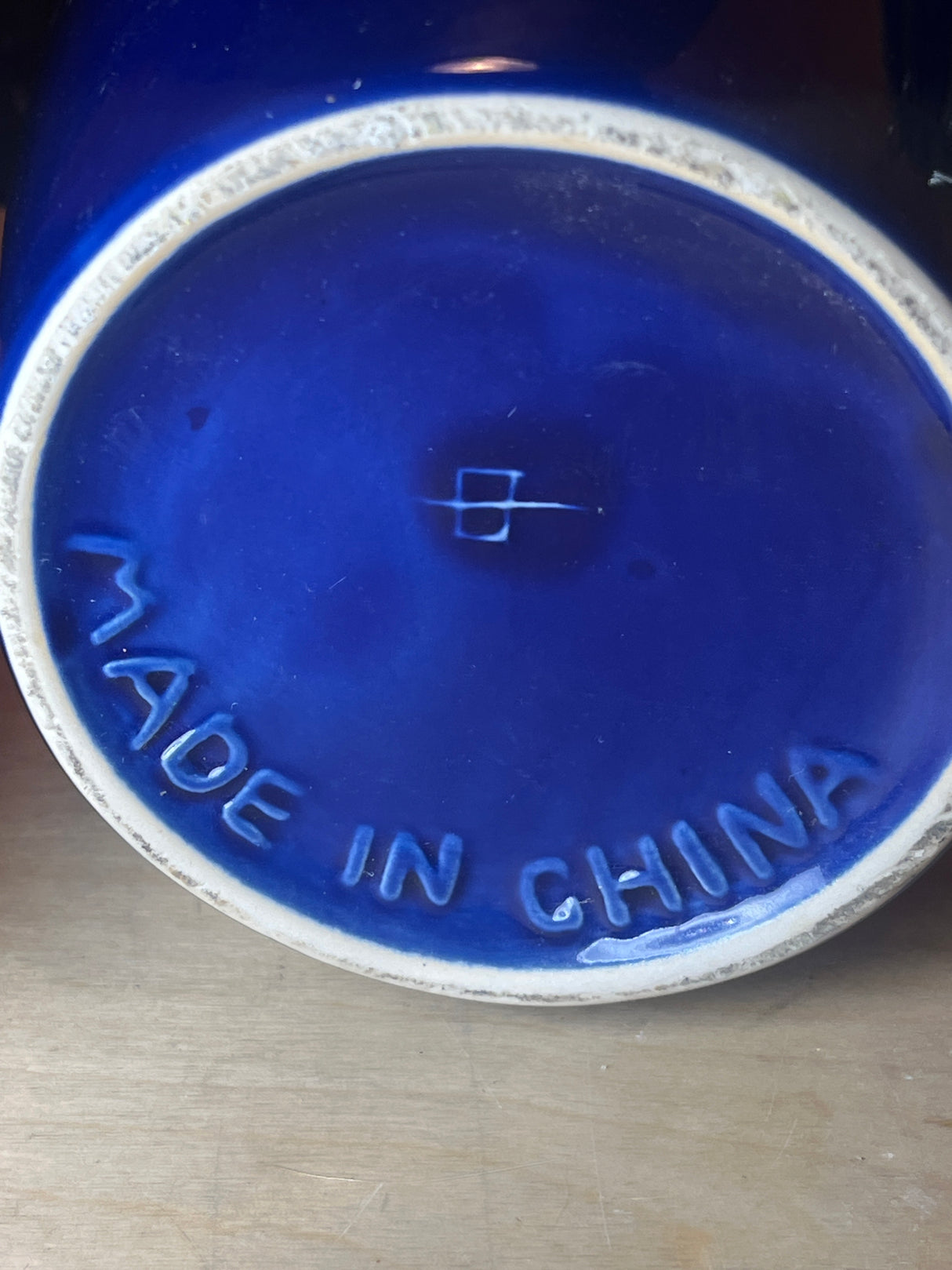 Set of 3 jars - cobalt blue ceramic with locking lids, showcasing the underside with MADE IN CHINA mark and maker's symbol, highlighting craftsmanship and origin.