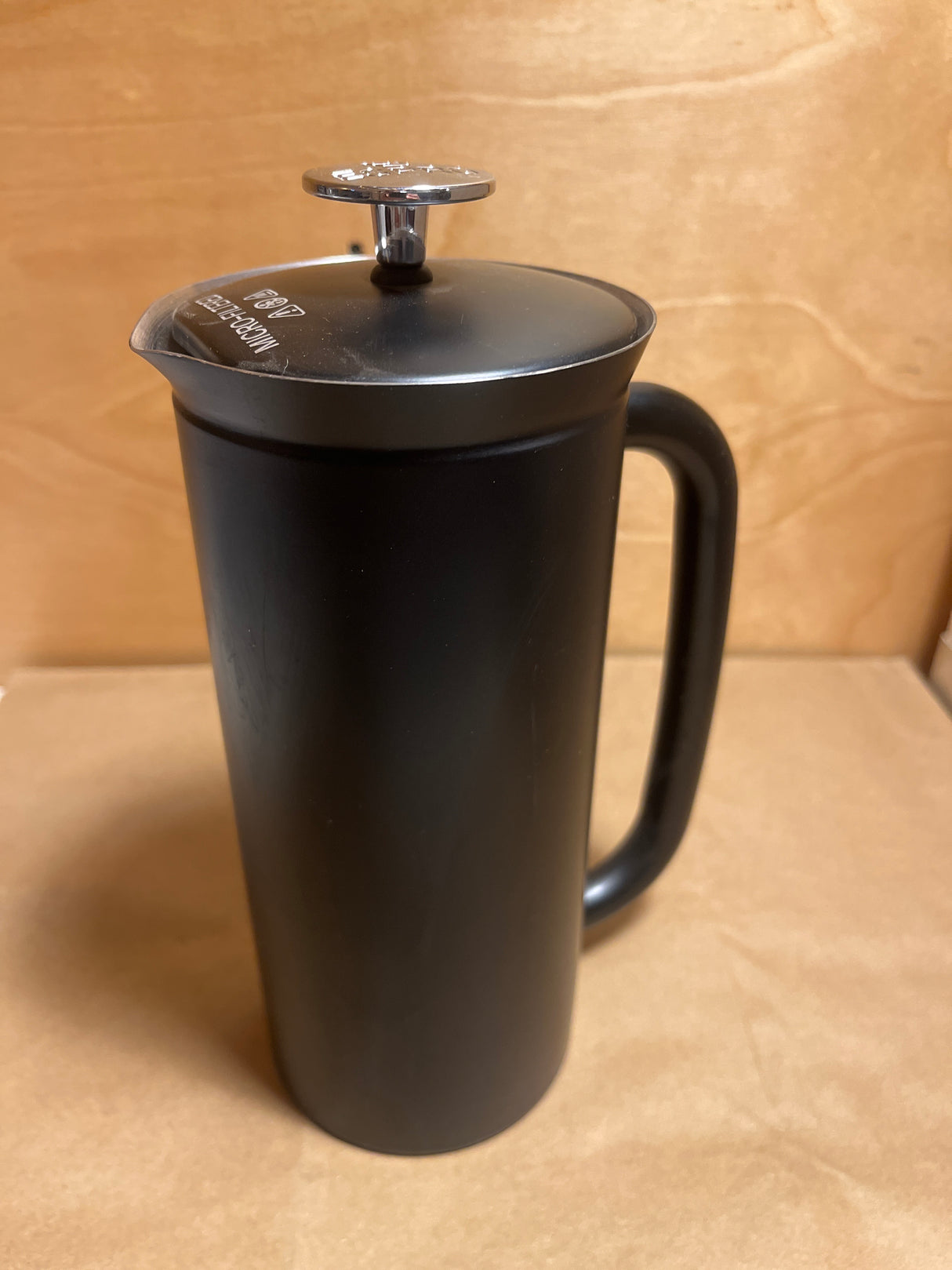 Espro French press coffee maker with a sleek stainless-style design, featuring a cylindrical body, sturdy handle, and a lid with a plunger knob.