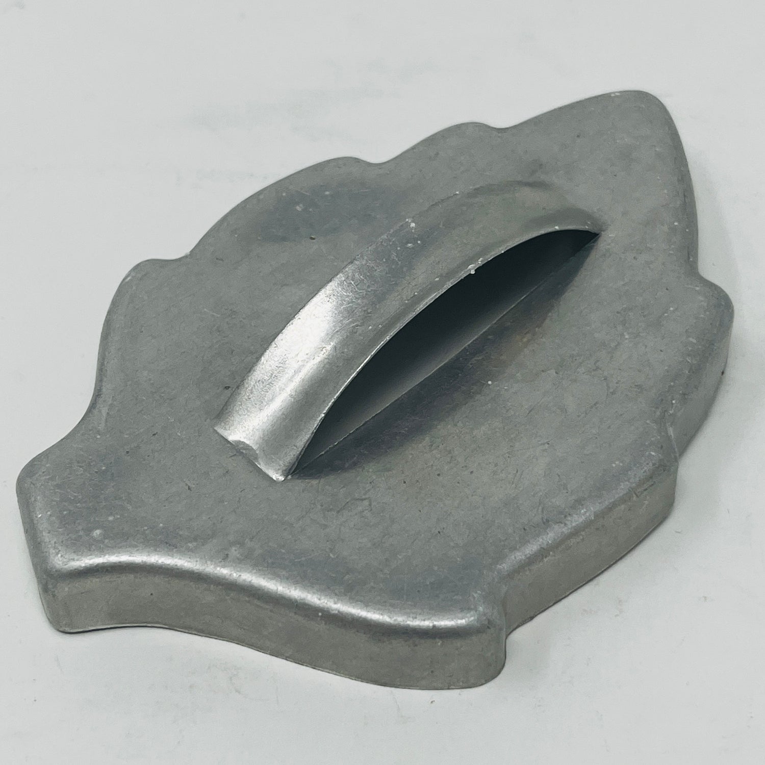 Mid-century metal cookie cutter with a large handle for easy grip, ideal for creating various shapes, including holiday and celestial designs.