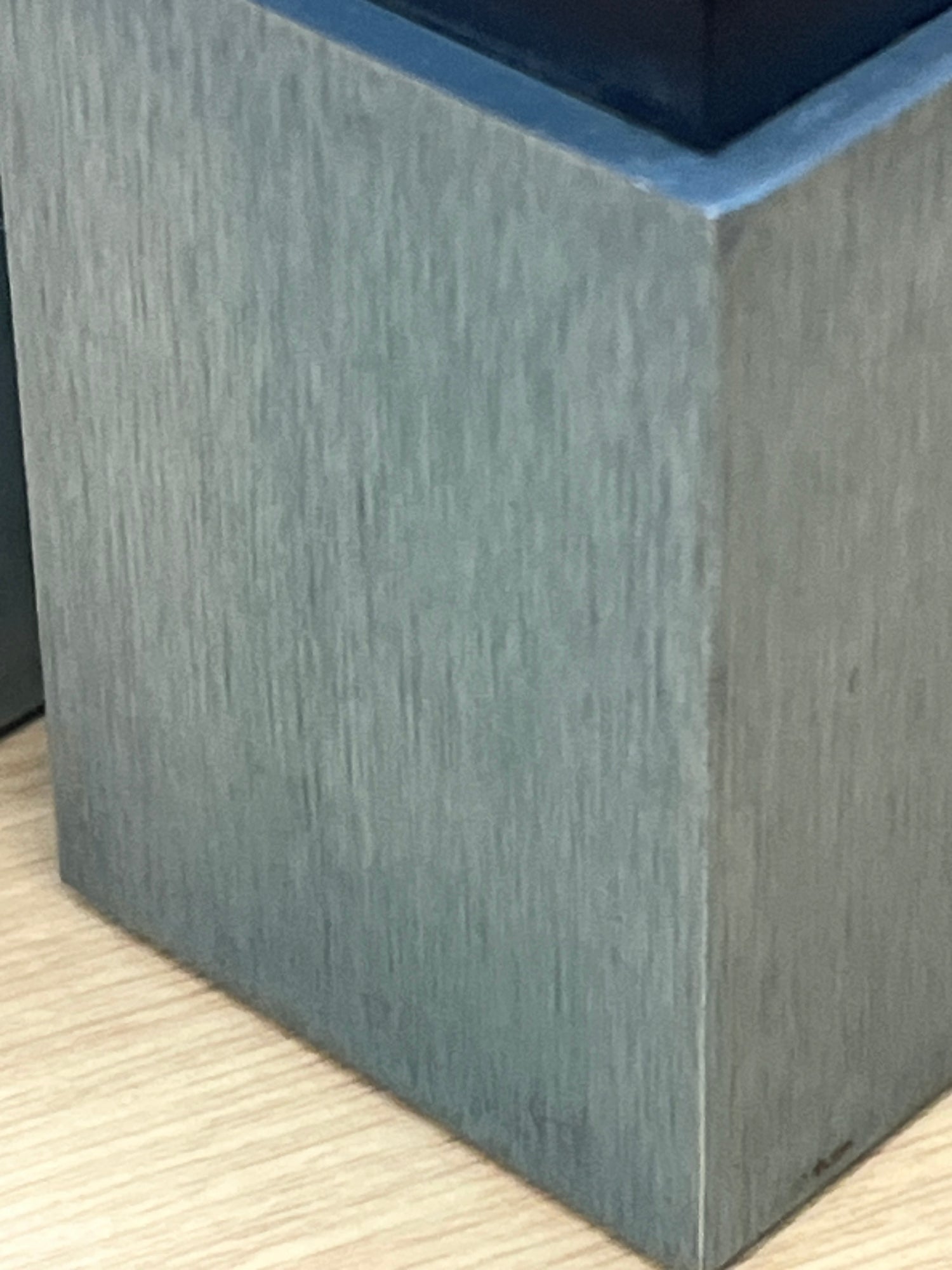 Elika anodized aluminum salt and pepper shakers by David Tisdale, 1988, displayed on a wood surface, featuring a geometric, Memphis-style design.