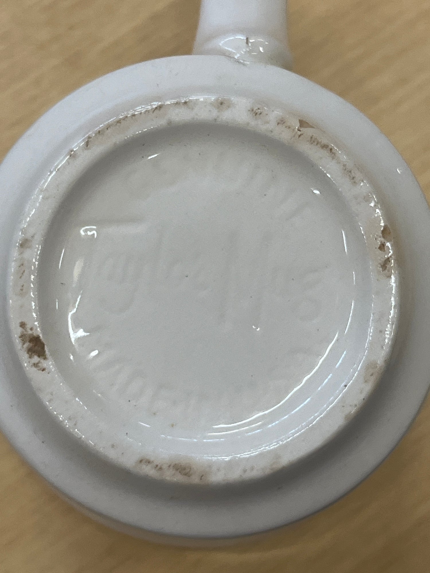 1950s Genuine Taylor ceramic teal and white diner mug with visible brown wear spots, showcasing a durable design with a hint of teal inside.