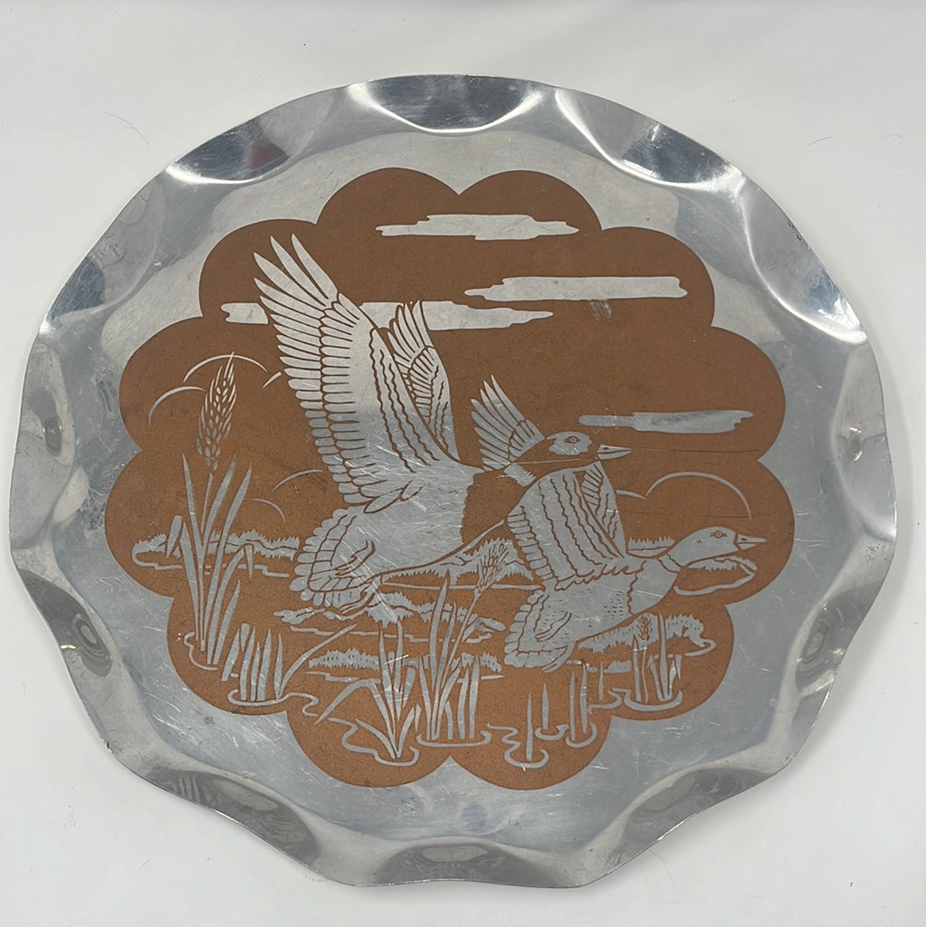 Metal serving tray featuring a majestic mallard duo emerging from water, with a scalloped edge. Price reflects minor scratches and scuff marks, no cracks.