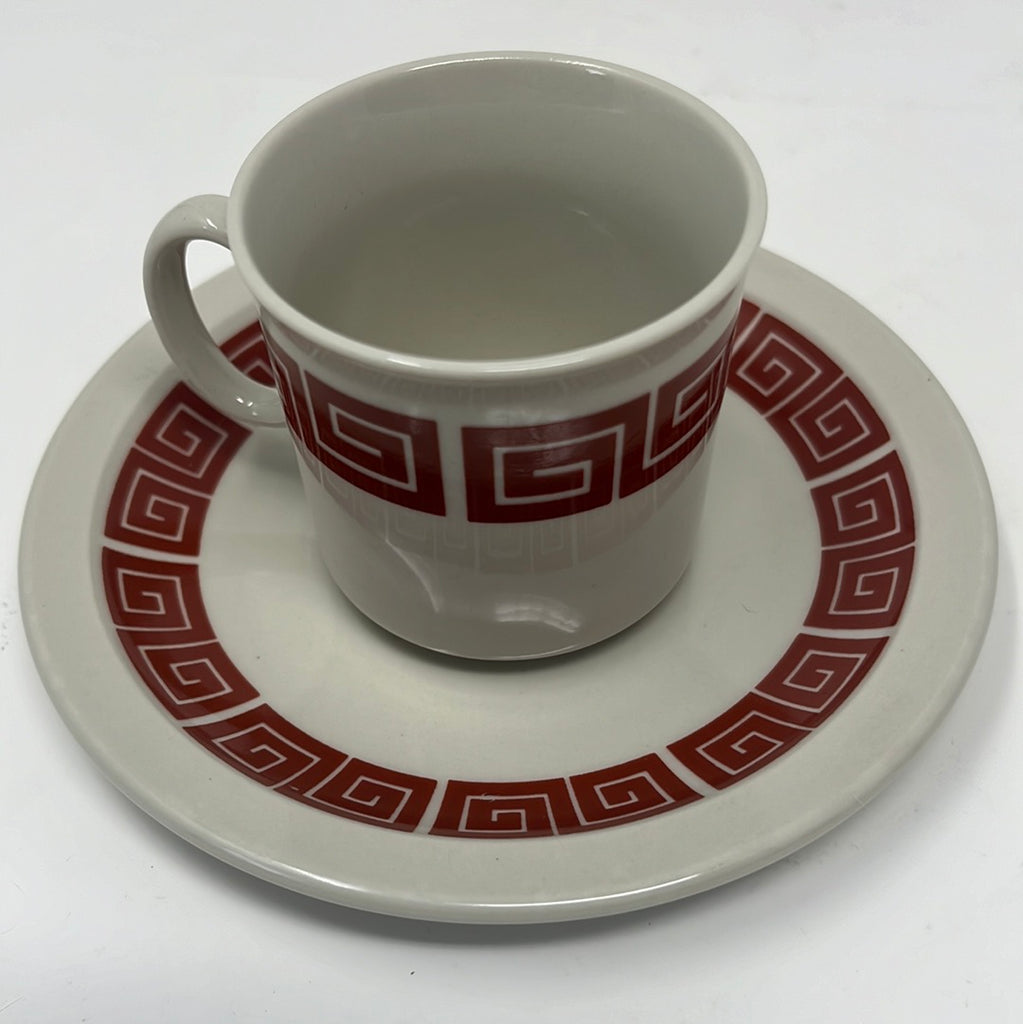 Espresso cup and saucer set with bold geometric coral trim design, ceramic serveware for coffee lovers.