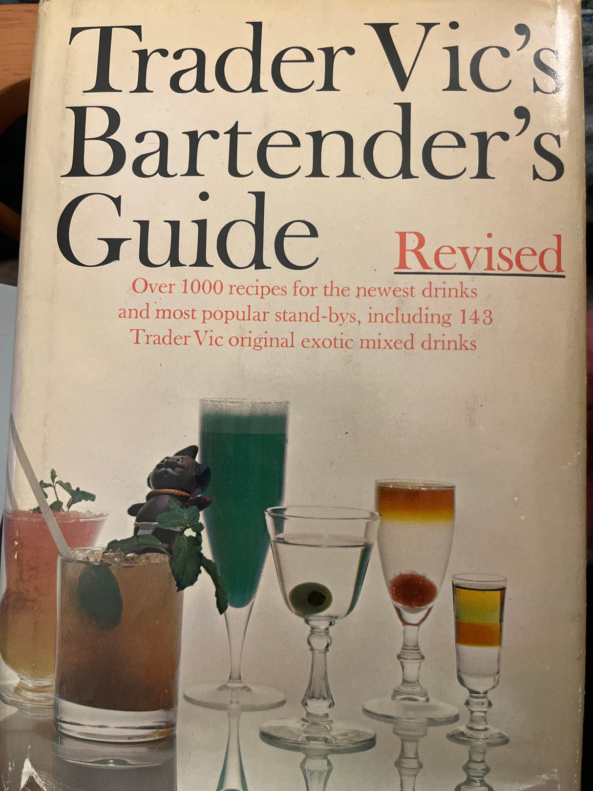 Trader Vic’s Bartender’s Guide (Revised 1972) cover featuring cocktail glasses and promises over 1000 updated drink recipes, including 143 Trader Vic originals.