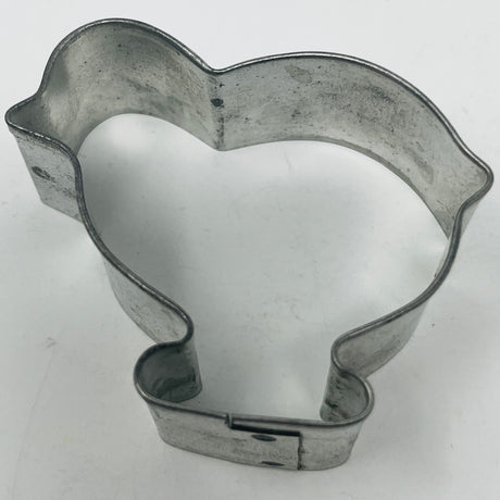 Mid-century metal cookie cutter on a white surface, featuring an adaptive design with a large handle for easy grip, inspired by 1930s styles.