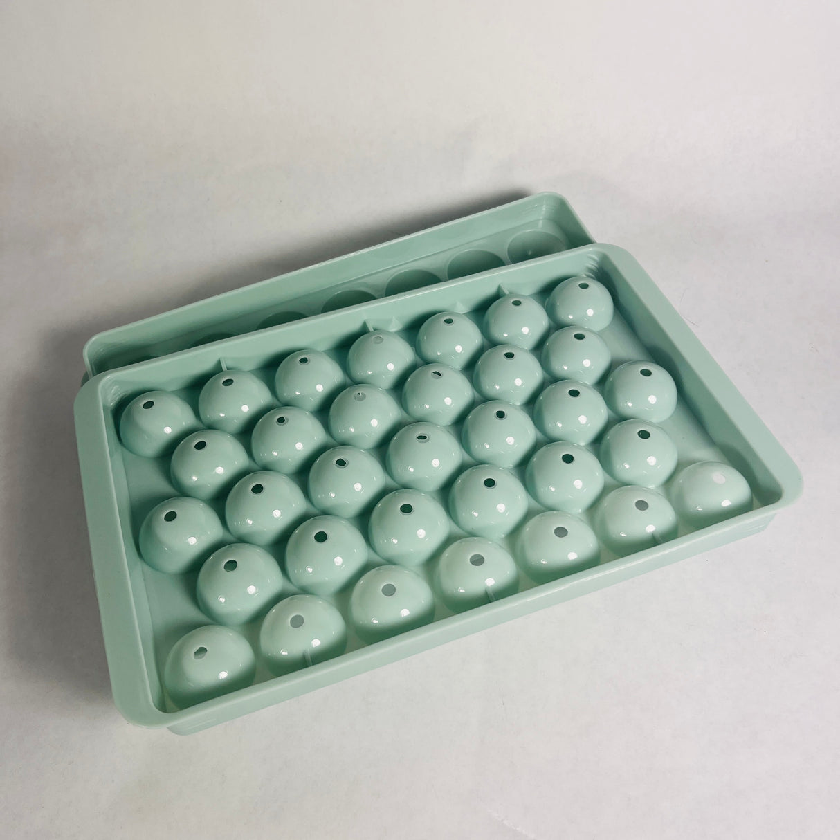 Wibimen turquoise mini sphere ice cube tray set on a white background.