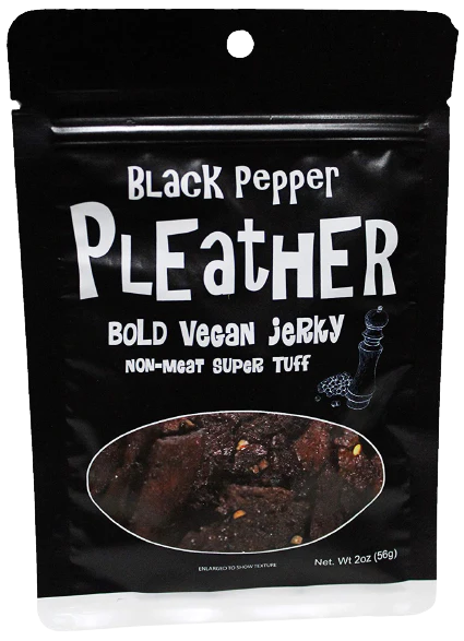 Pleather Vegan Jerky package with Black Pepper labeling, showing pepper-speckled strips through a clear window. Seitan-based, resealable 2 oz pack for on-the-go snacking.