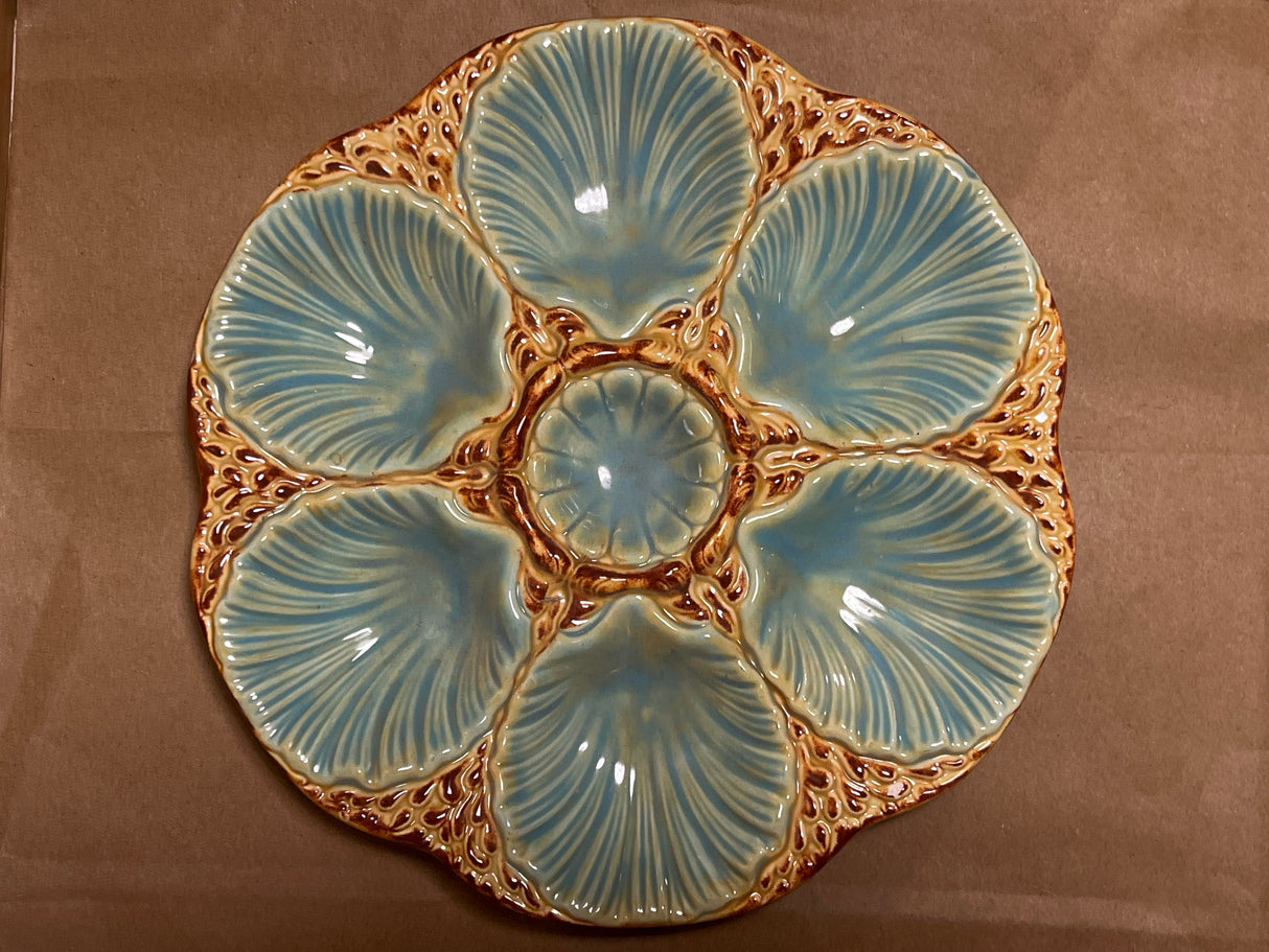 RARE French majolica oyster plate with scallop-shaped wells and central sauce well, showcasing antique craftsmanship with intricate detailing and a gentle patina.