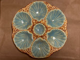 RARE French majolica oyster plate with scallop-shaped wells and central sauce well, showcasing antique craftsmanship with intricate detailing and a gentle patina.