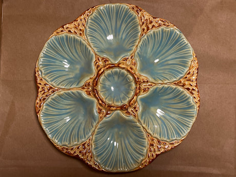 RARE French majolica oyster plate with scallop-shaped wells and central sauce well, showcasing antique craftsmanship with intricate detailing and a gentle patina.