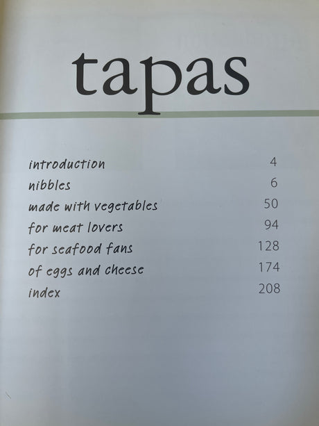 Cover of 'Tapas... Made Simple' cookbook, showcasing a menu page highlighting the variety and simplicity of tapas recipes included inside.