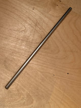 Stainless steel reusable drinking straw on a wooden surface, showcasing its sleek and durable design for eco-friendly beverage consumption.