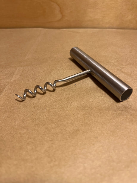 Stelton stainless steel minimalist corkscrew with a T-handle and spiral worm, designed for effortlessly removing corks from wine bottles.