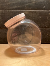 OXO POP medium food storage jar 3 qt., clear plastic with pale-pink lid, rests on its side, showcasing its easy-open design and spacious, accessible opening.