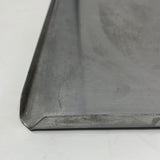 A close-up of a heavy-duty stainless steel pan, showing scratches on the surface. Lightweight and sturdy, suitable for baking.