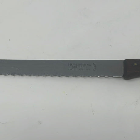 Vintage serrated knife by Oskar Kemper K-G Solingen Rostfrei, 1950s. Sharp blade, lightweight wood handle.