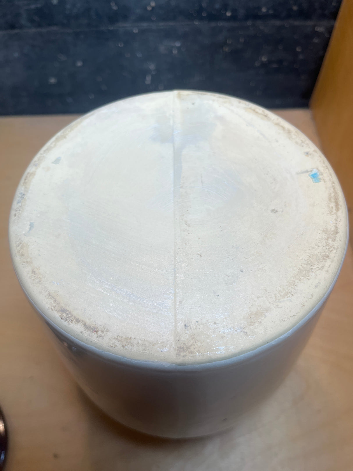 Vintage two-toned ceramic pot with lid, shown upside-down, revealing its unglazed bottom, mold-line seam, and rough foot-ring, ideal for storing pantry items.