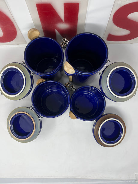 Oggi cobalt blue ceramic food storage containers with wooden scoops, set of 4, featuring snap lids for airtight sealing, displayed in a group.