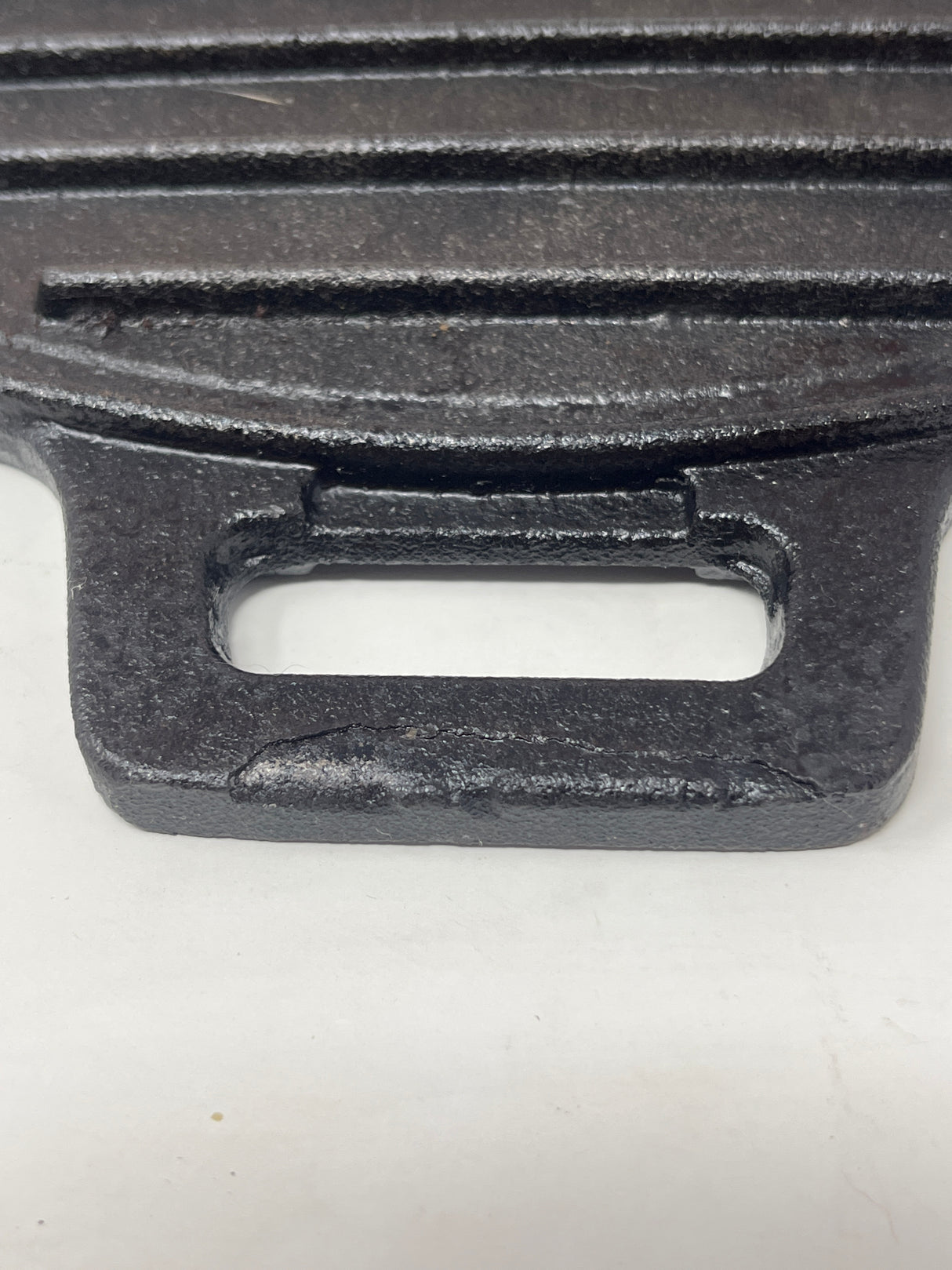 Cast iron ridged grill pan with handles, designed for even heat distribution, ideal for searing on gas stoves and outdoor grills.