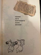 Trader Vic’s Bartender’s Guide (Revised 1972) title page with a newspaper clipping about the Singapore Sling recipe, featuring cartoon pig-like figures with dice and tankard.