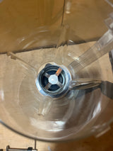 Top view of an empty GSI Outdoors Vortex hand-cranked blender jar, showcasing plastic sides, fins, and metal blade assembly at the bottom.