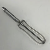 A sharp EKCO stainless steel vegetable peeler with floating blade, featuring a curved tip for precise cutting. Inscription: “NEE ACTION PAT. NO 2232940”.