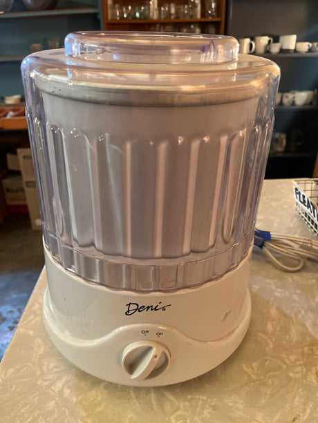 Automatic ice cream maker - Deni 5100 on a counter, featuring a clear lid, on/off dial, and Deni logo, ideal for quick, homemade frozen desserts.