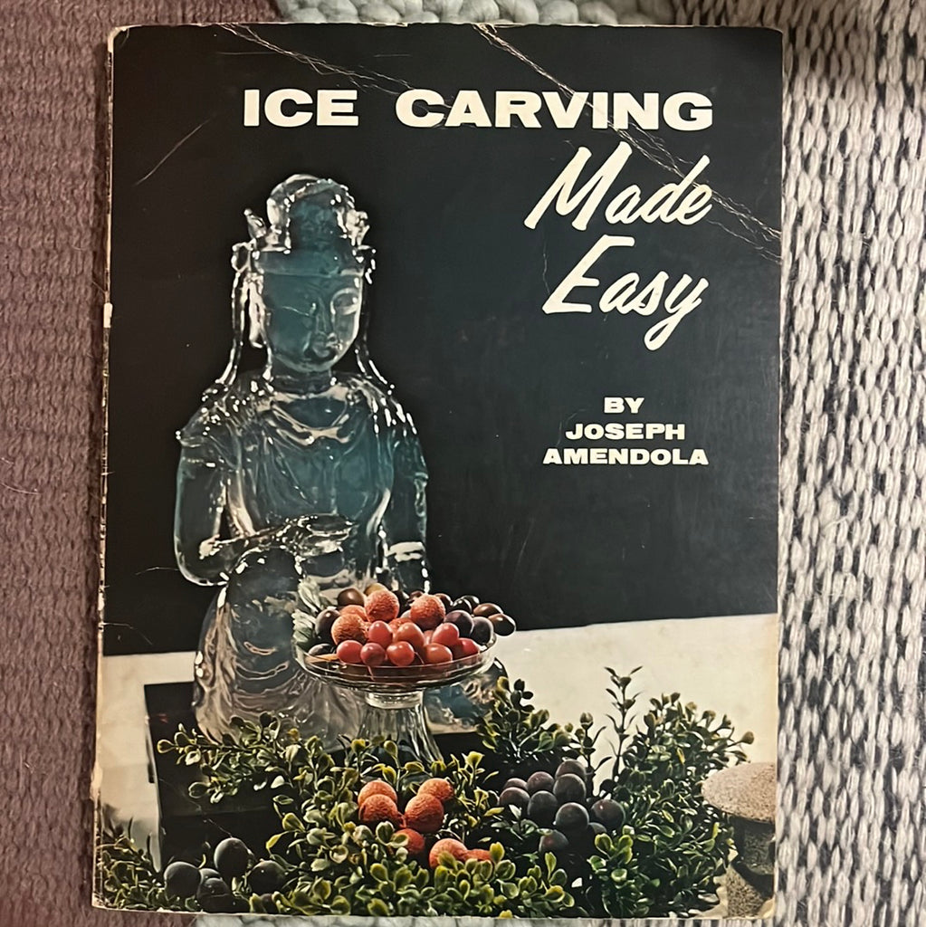 Ice Carving Made Easy: Book with ice carving statue of a Hindu god holding a bowl overflowing with fruit. From Spoons Kitchen Exchange.